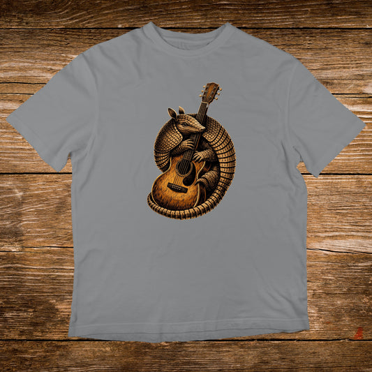 Armadillo playing an acoustic guitar on a grey t-shirt.