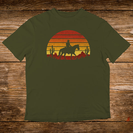 Olive t-shirt with a sunset silhouette of a cowboy on horseback.