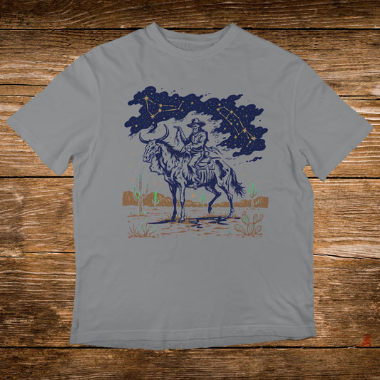Cowboy riding a horse with constellations and desert landscape.