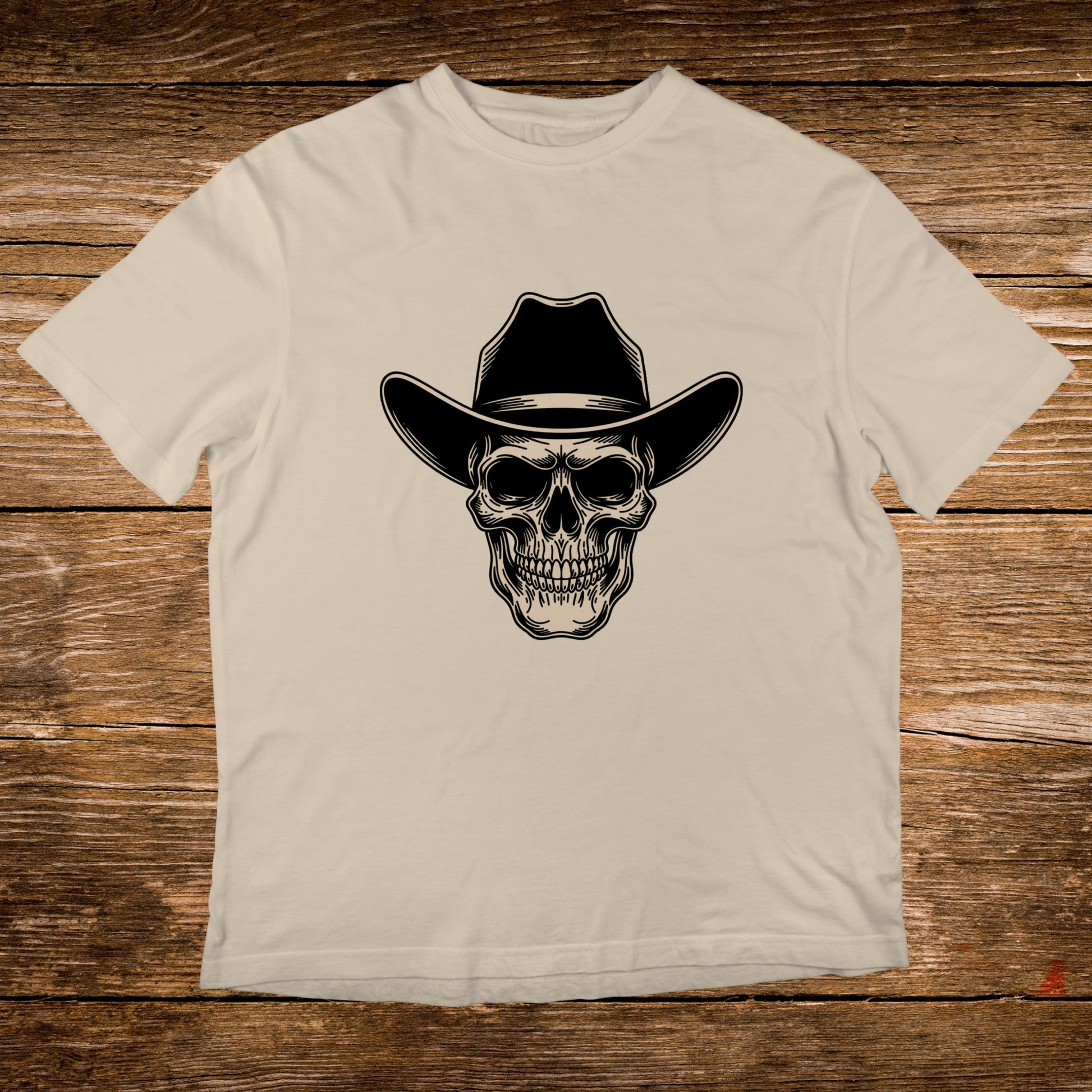 Cream t-shirt with a black cowboy hat and skull graphic.