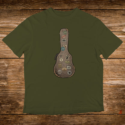 Olive t-shirt with a brown guitar case graphic adorned with travel stickers.