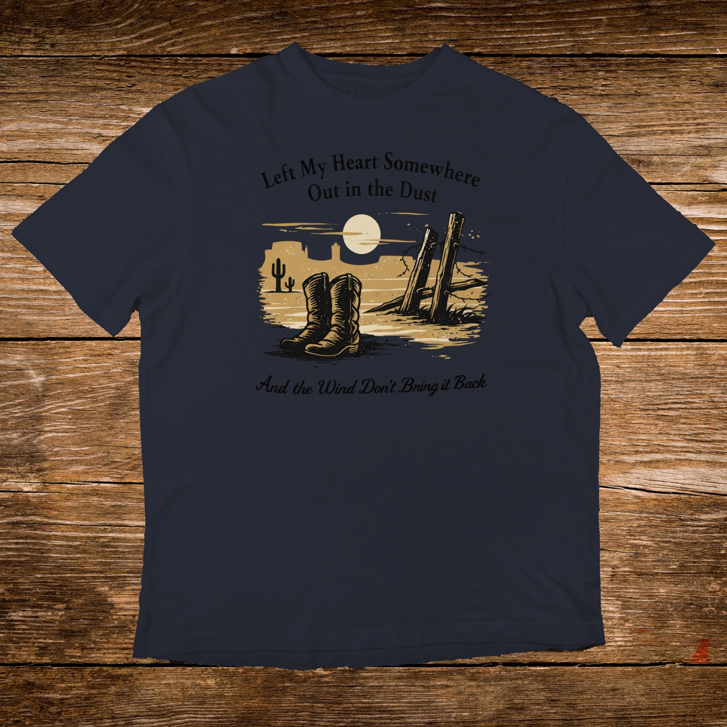 Navy t-shirt with cowboy boots, desert scene, and text: "Left My Heart Somewhere Out in the Dust And the Wind Don't Bring it Back"