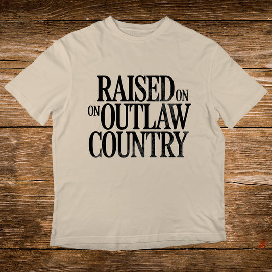 Cream t-shirt with "Raised on Outlaw Country" text.