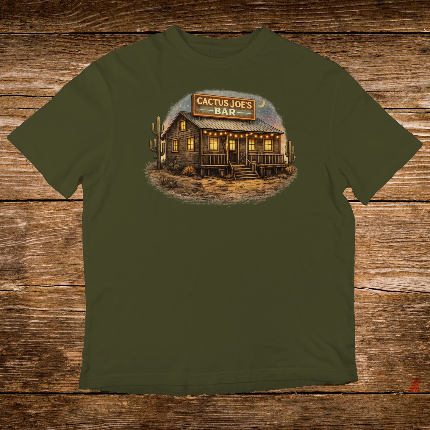 Green t-shirt with Cactus Joe's Bar nighttime desert scene graphic.