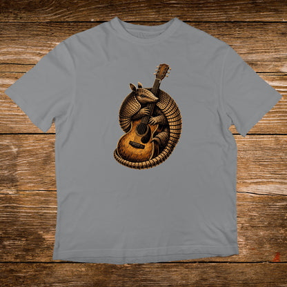 Armadillo playing an acoustic guitar on a grey t-shirt.