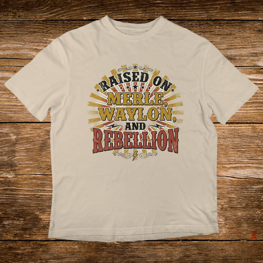 Cream t-shirt with "Raised on Merle, Waylon, and Rebellion" text.