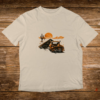 Vintage truck with guitar on road with desert landscape and sunset.