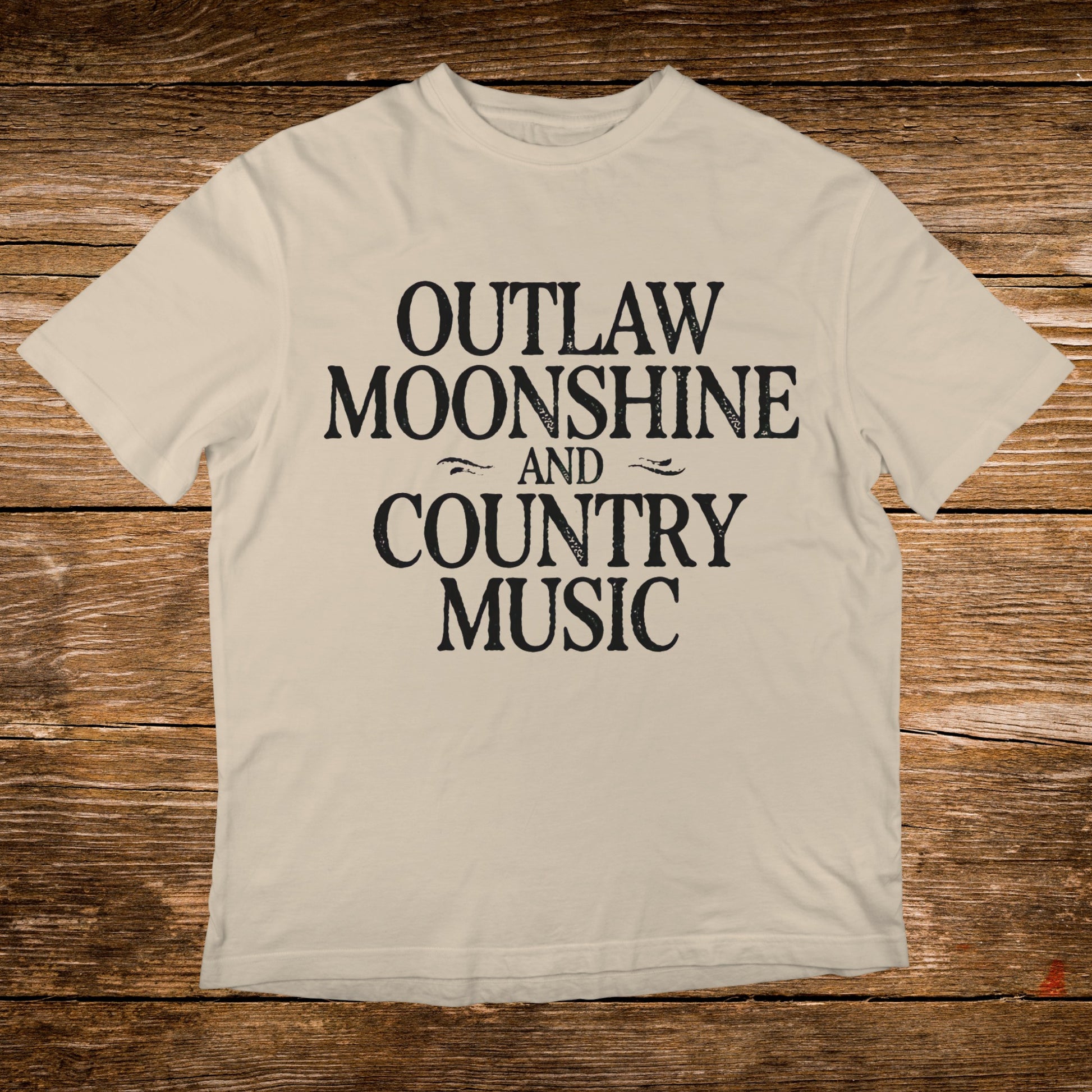 Cream t-shirt with black text "OUTLAW MOONSHINE AND COUNTRY MUSIC".