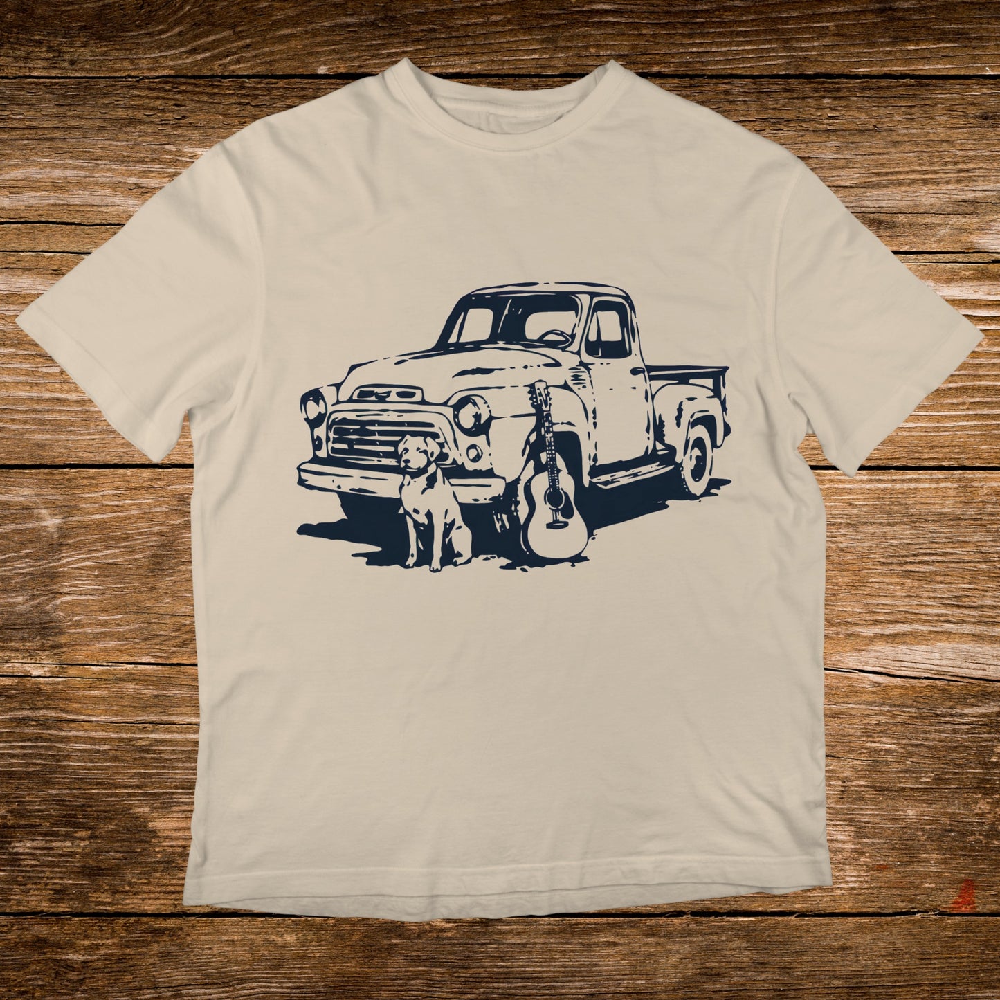 Cream t-shirt with navy graphic of vintage truck, dog, and guitar.