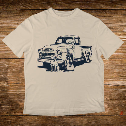 Cream t-shirt with navy graphic of vintage truck, dog, and guitar.
