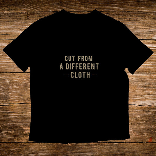 Black t-shirt with "CUT FROM A DIFFERENT CLOTH" text.