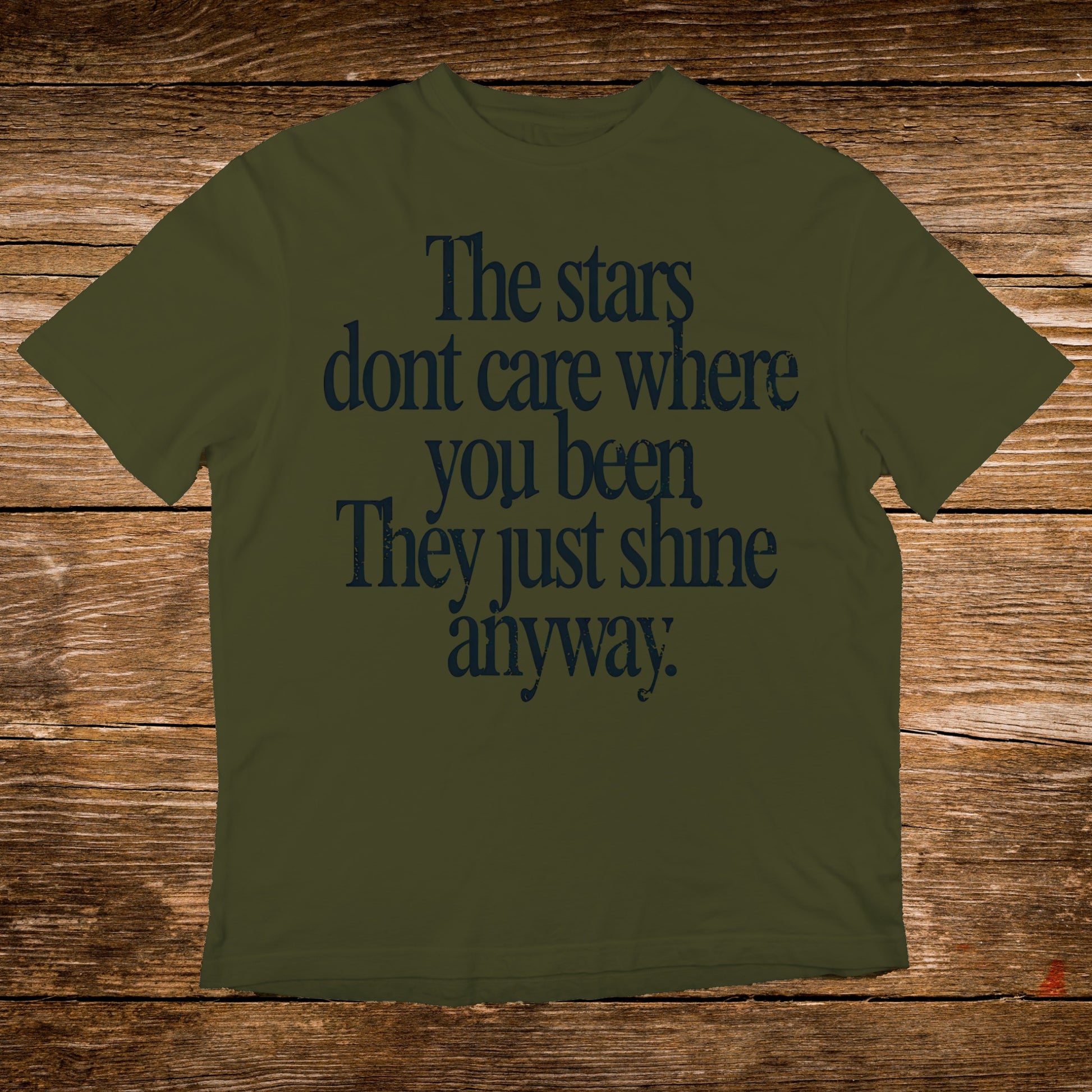 Olive green t-shirt with "The stars dont care where you been They just shine anyway" text.
