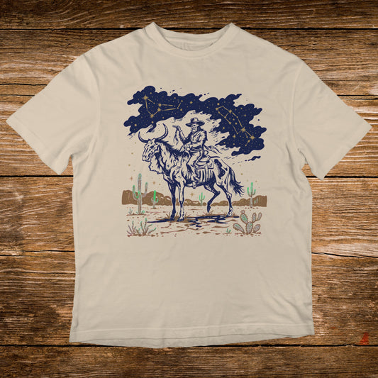 Cowboy on horseback under starry sky with desert landscape.