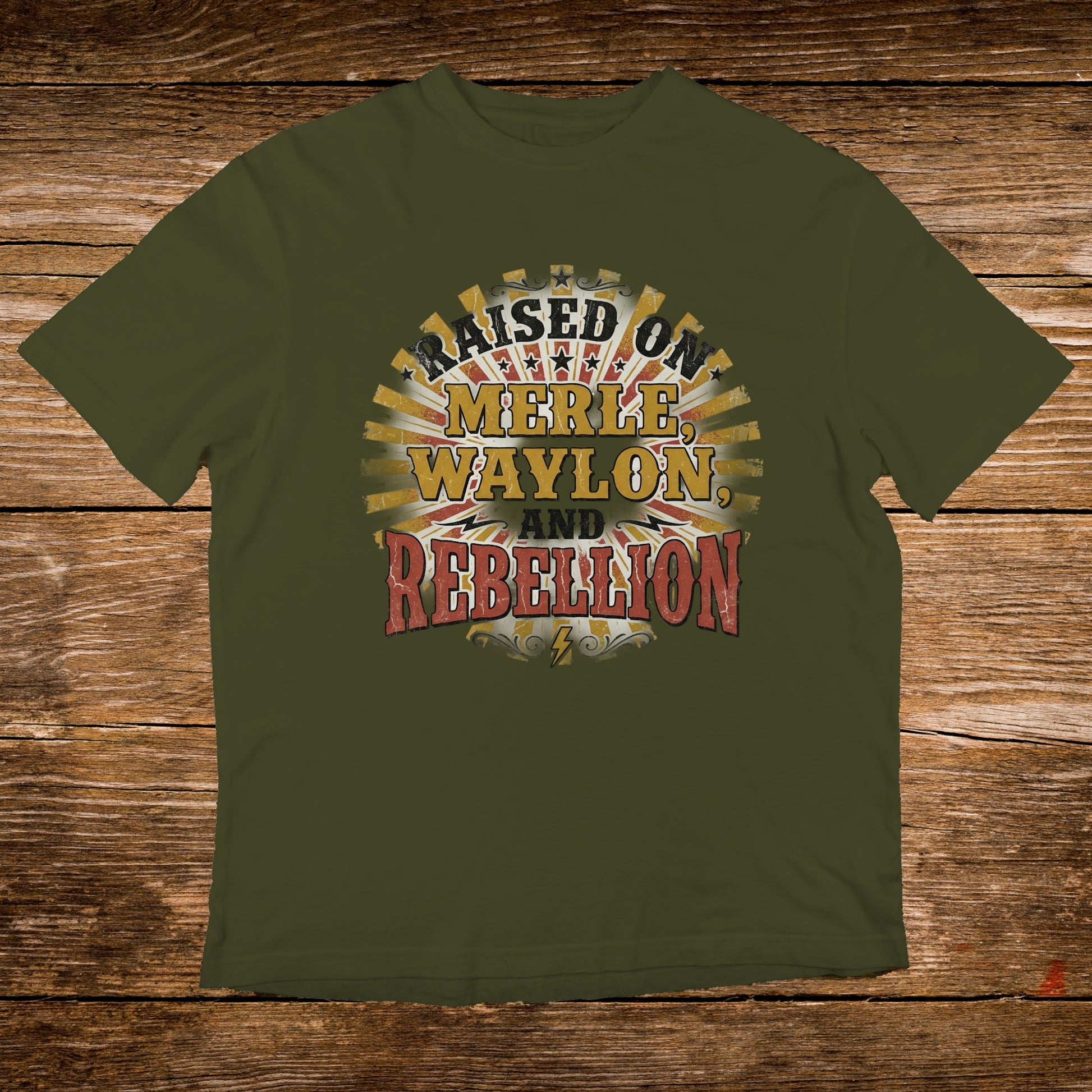 Olive green t-shirt with "Raised on Merle, Waylon, and Rebellion" text.