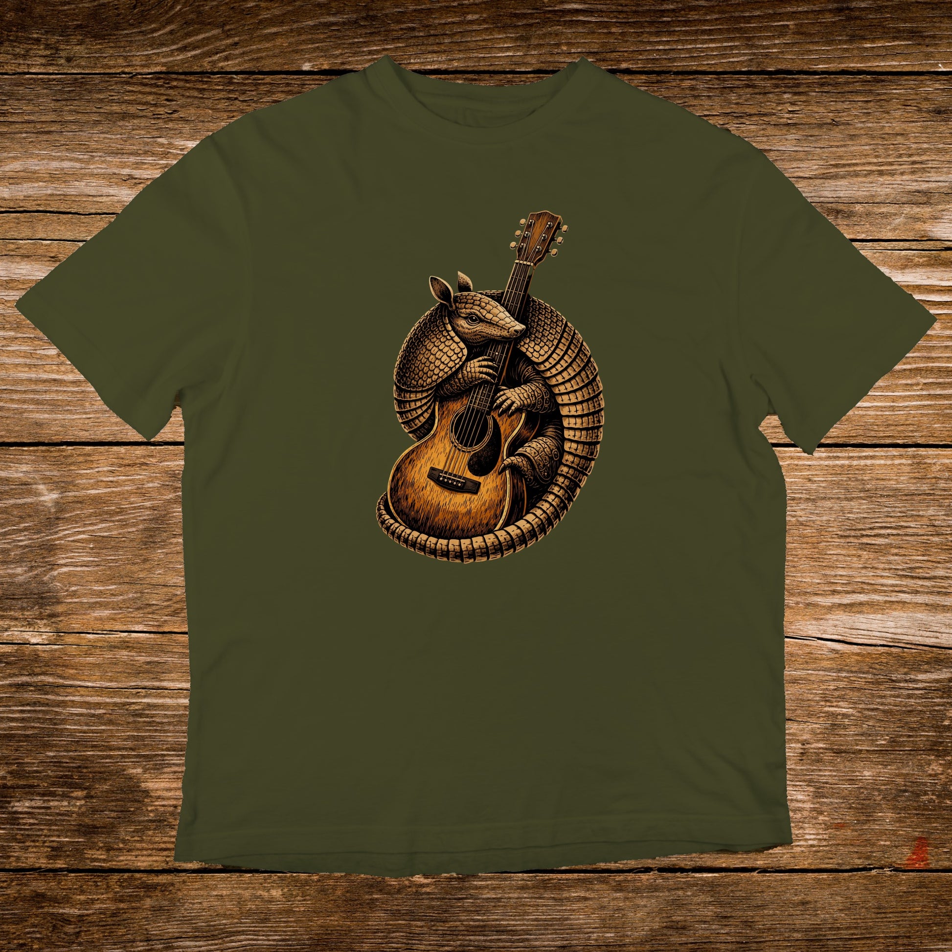 Armadillo playing an acoustic guitar on a dark green t-shirt.