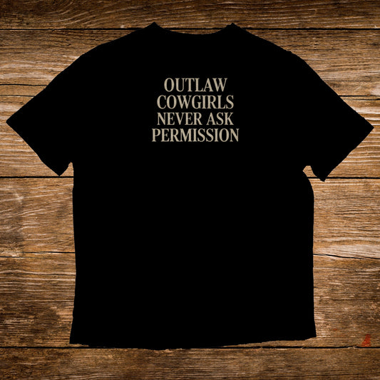 Black t-shirt with "OUTLAW COWGIRLS NEVER ASK PERMISSION" in white text.