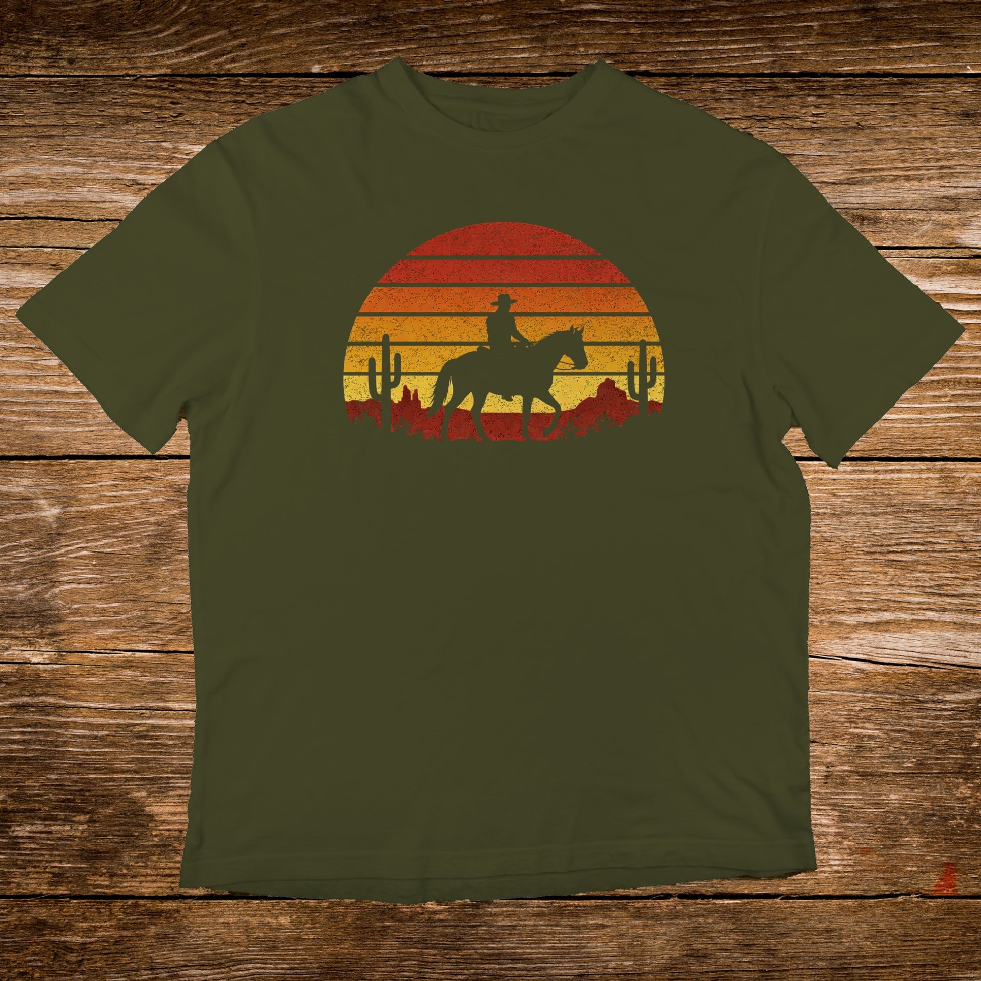 Olive t-shirt with a sunset silhouette of a cowboy on horseback.
