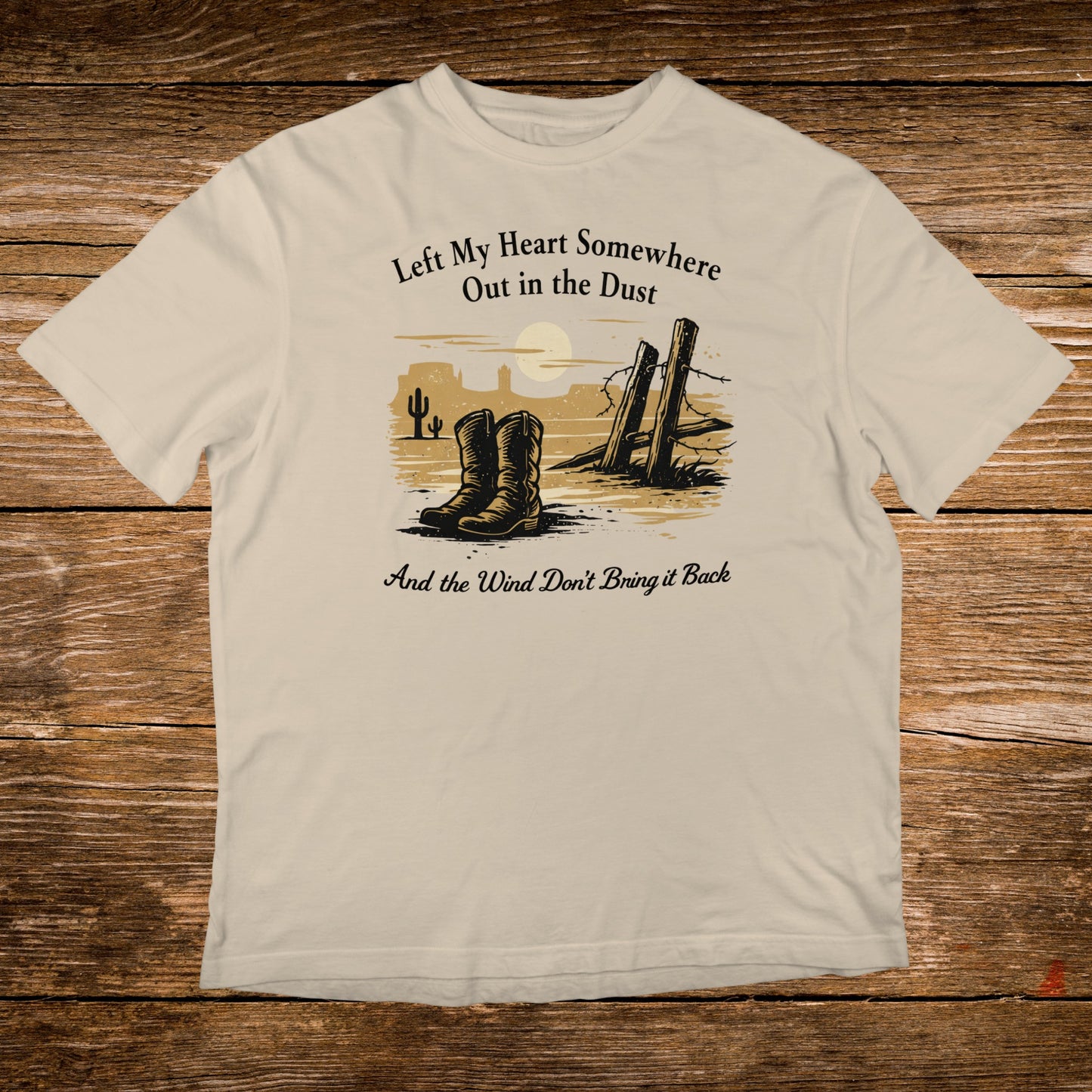 Cream t-shirt with cowboy boots, desert scene, and Western phrase.