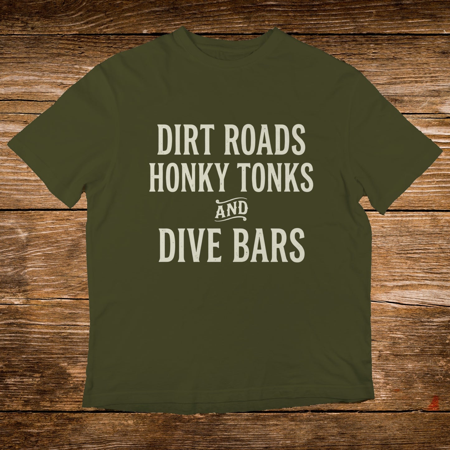 Olive green t-shirt with "Dirt Roads Honky Tonks and Dive Bars" in white text.