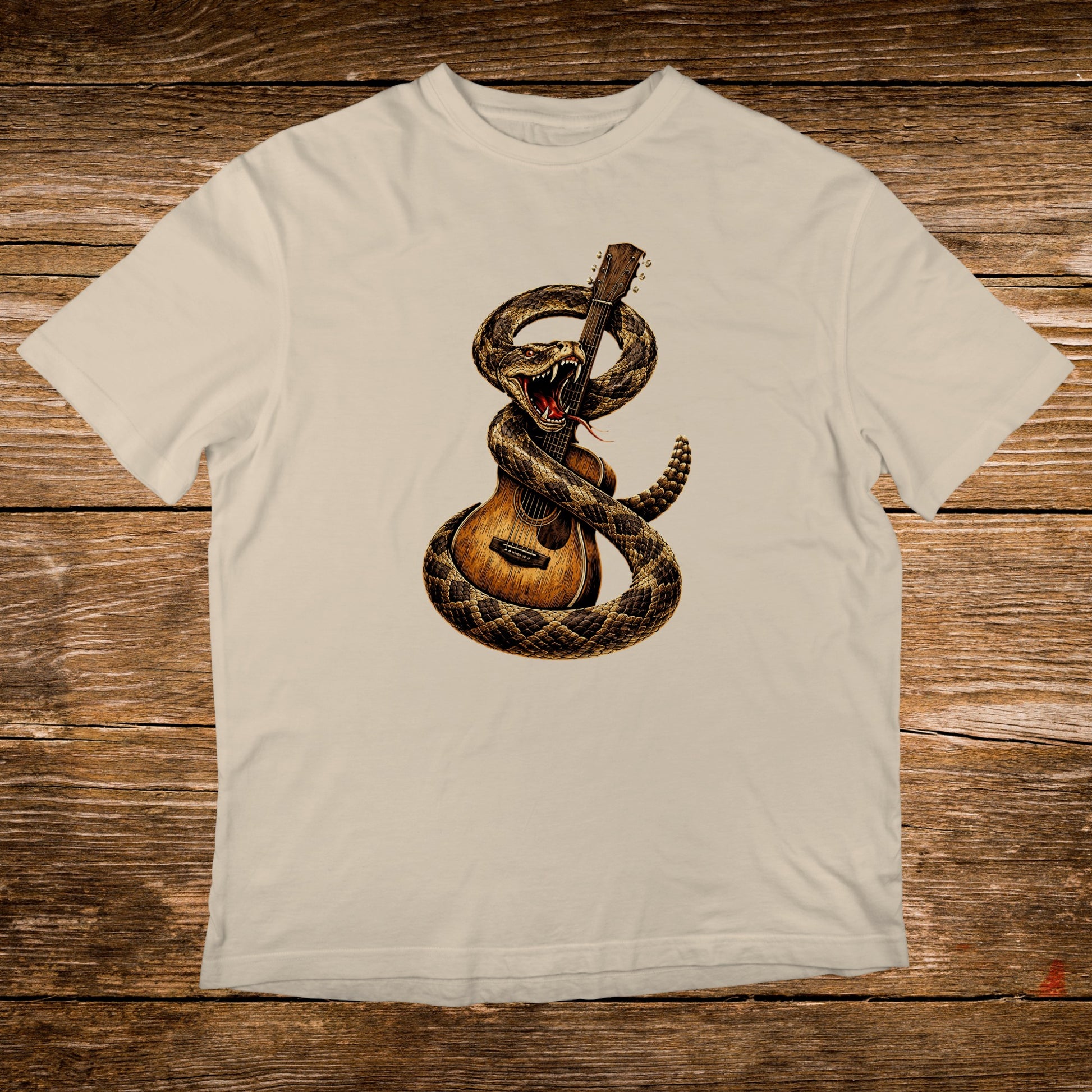 Rattlesnake coiled around acoustic guitar on a cream t-shirt.
