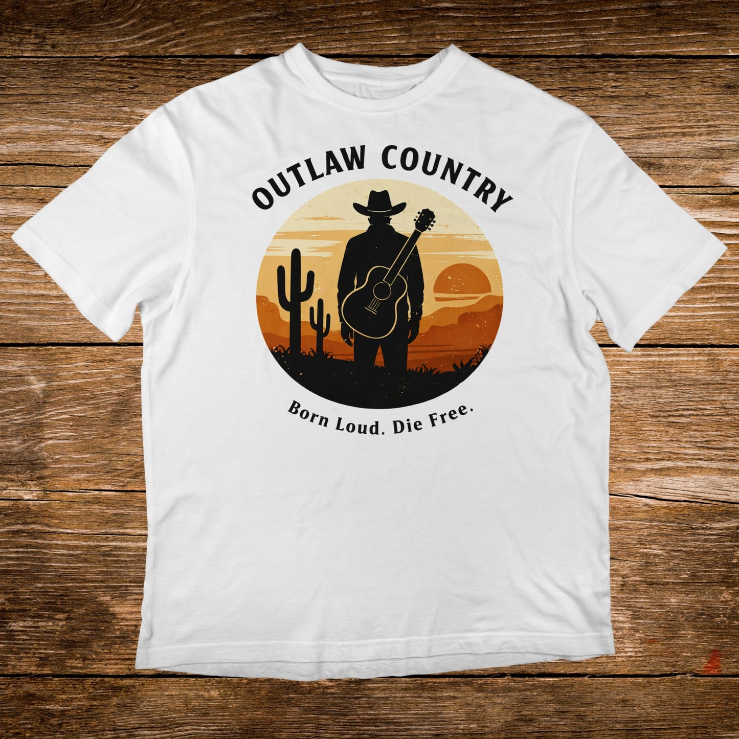 White t-shirt with "Outlaw Country Born Loud. Die Free." text and desert graphic.