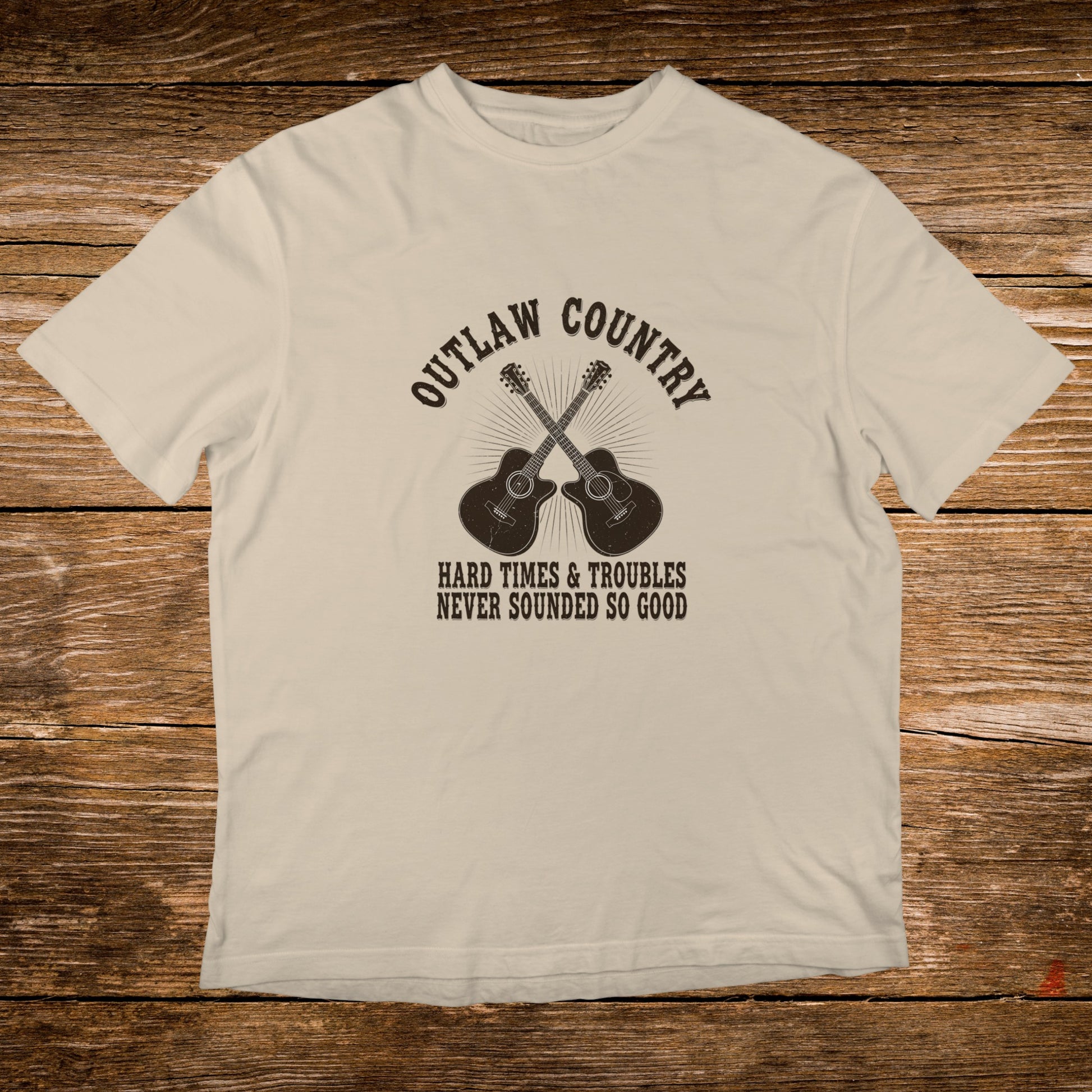 Cream t-shirt with crossed guitars and "Outlaw Country" text.