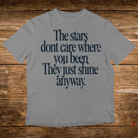 Grey t-shirt with "The stars dont care where you been They just shine anyway."