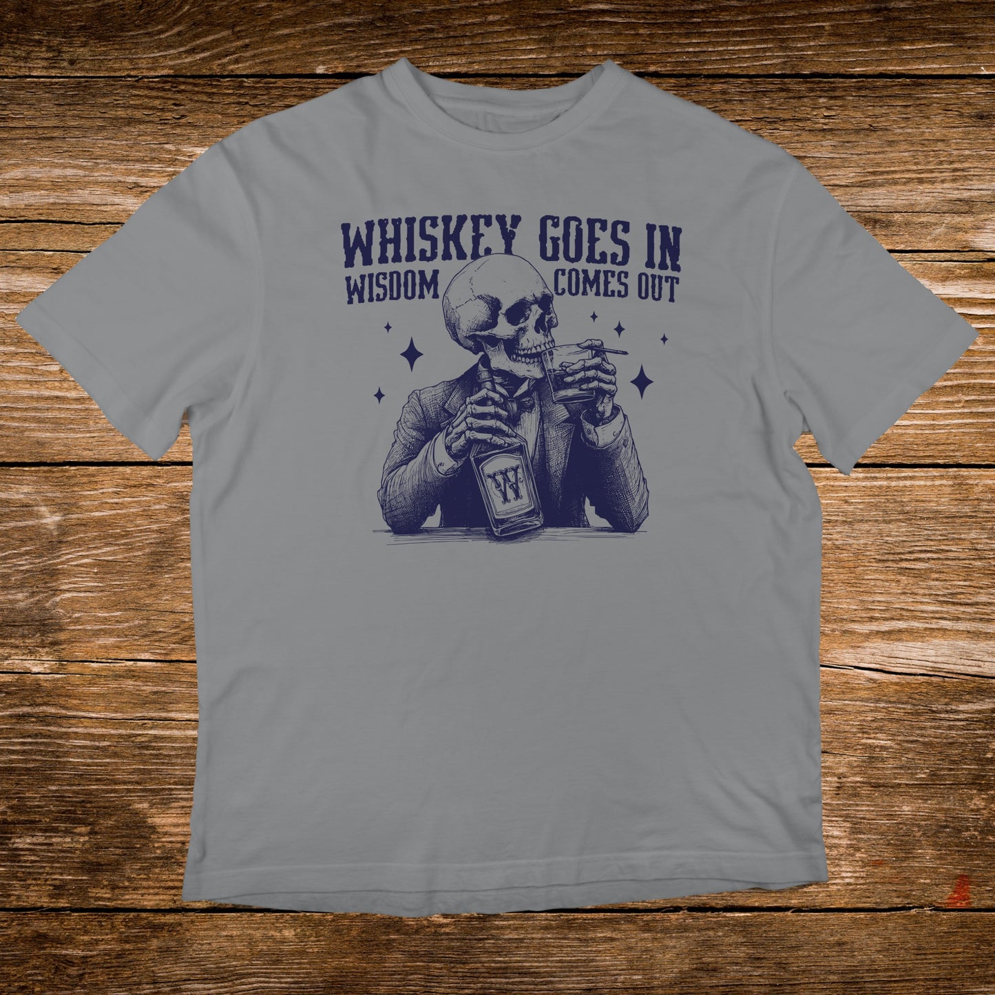 Skeleton in a suit drinking whiskey, text reads "Whiskey goes in, wisdom comes out."