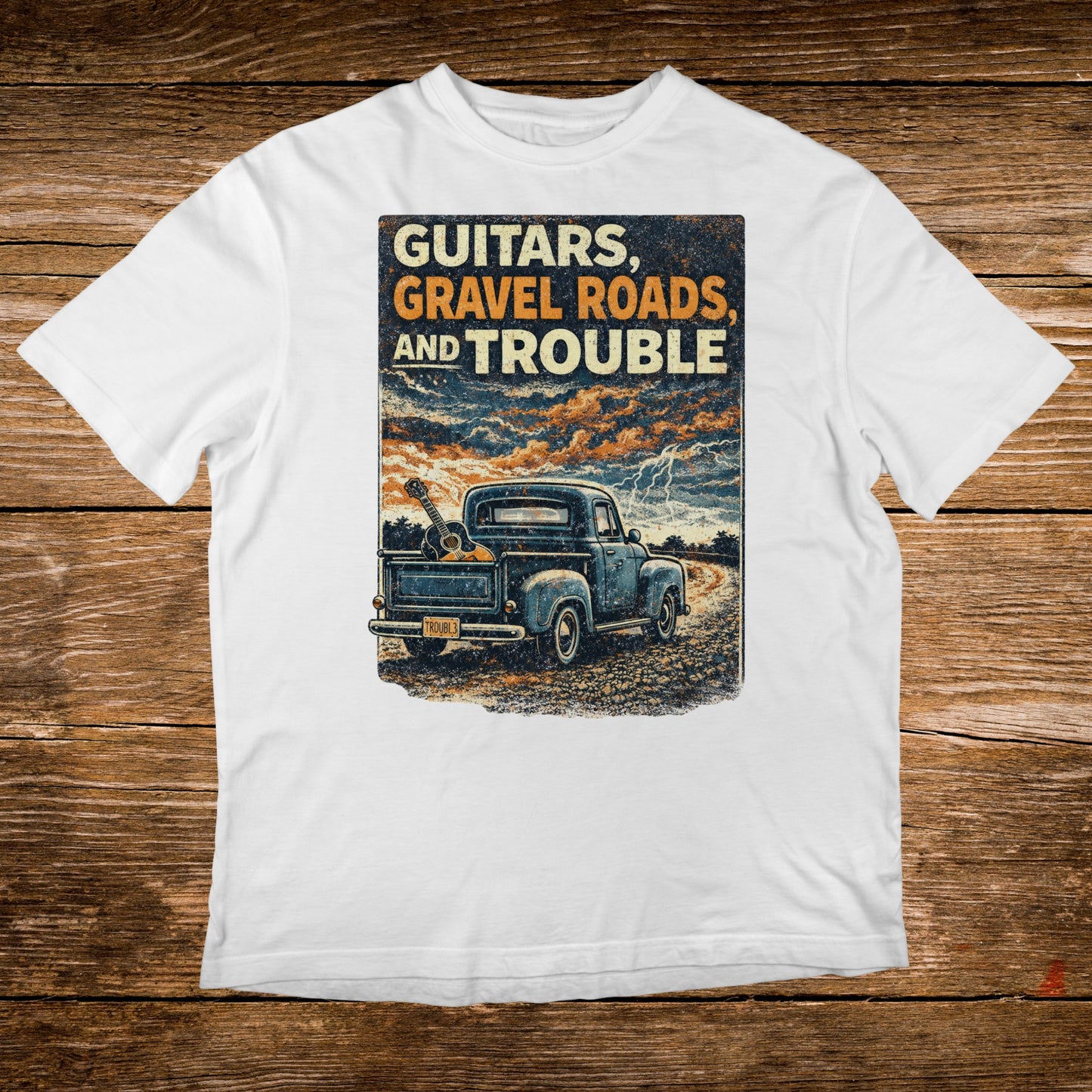 Vintage truck carrying guitars on a dirt road with stormy skies.