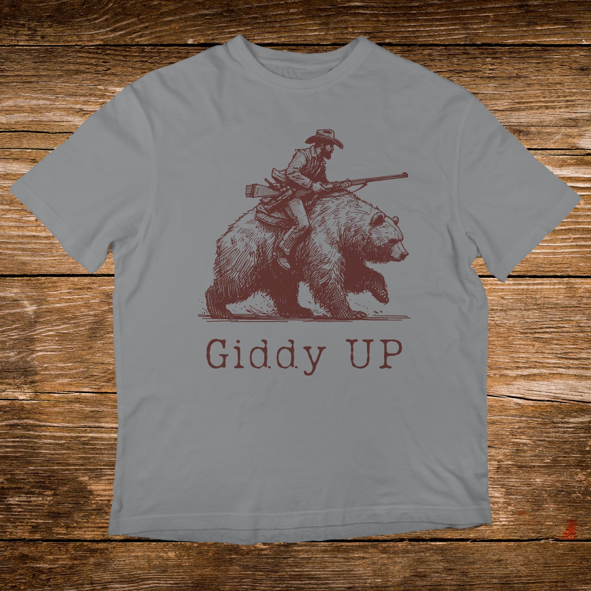 Brown grizzly bear with cowboy riding it, "Giddy Up" text.