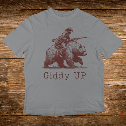 Brown grizzly bear with cowboy riding it, "Giddy Up" text.