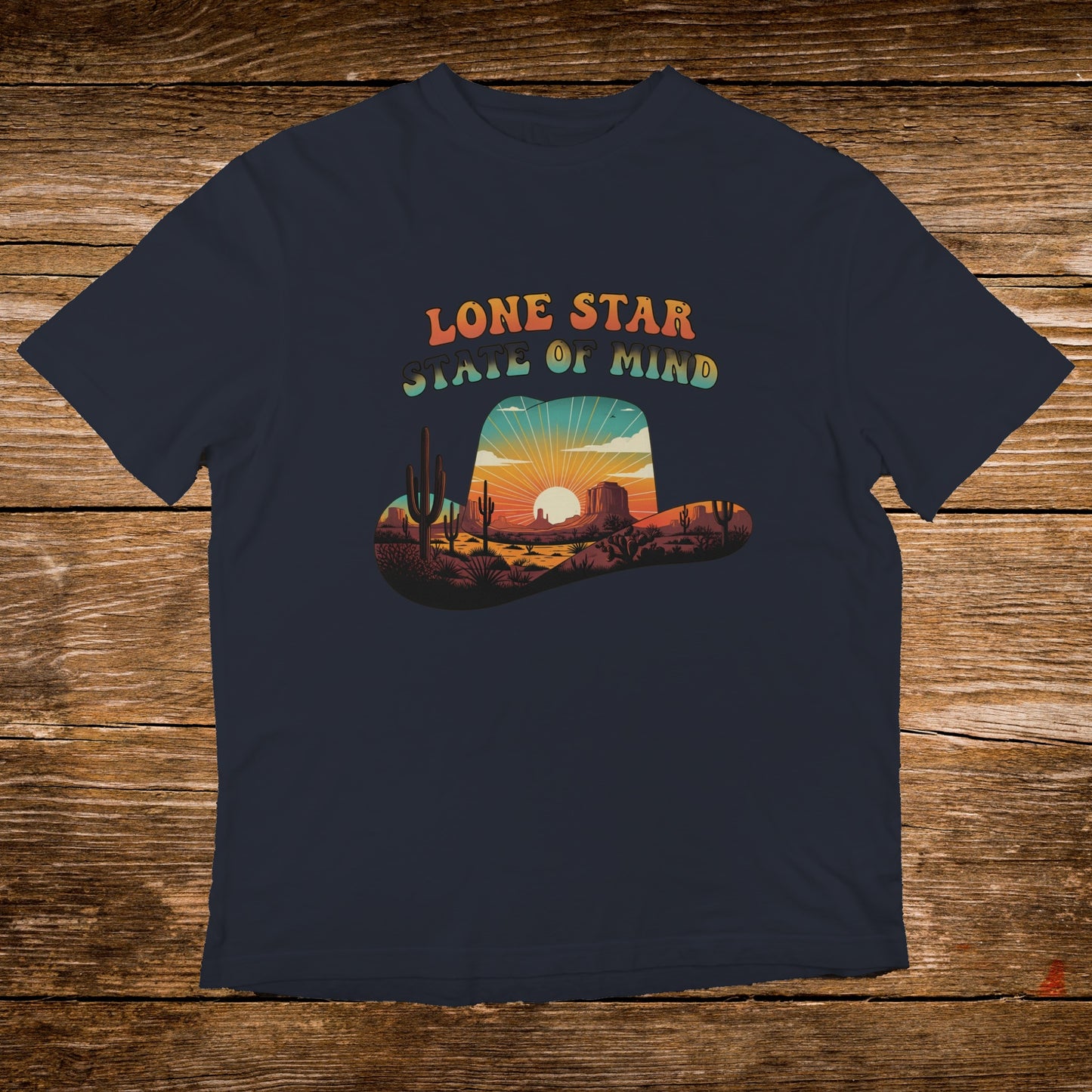Navy t-shirt with a vintage desert sunset scene inside a cowboy hat graphic.