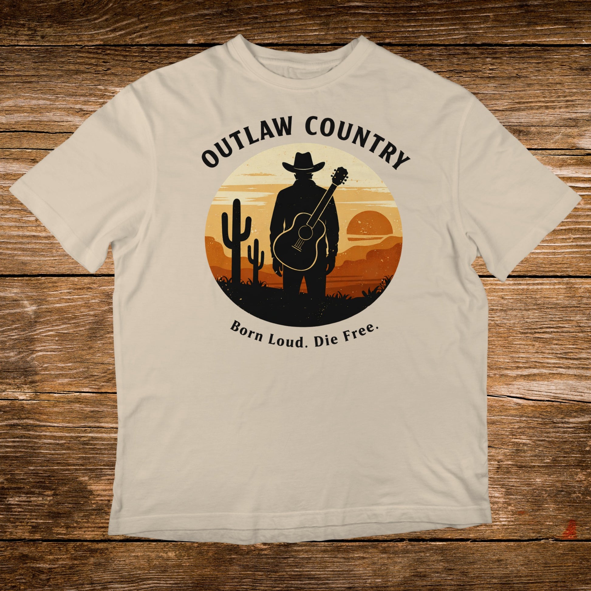 T-shirt with cowboy silhouette, guitar, cacti, and "Outlaw Country Born Loud. Die Free." text.