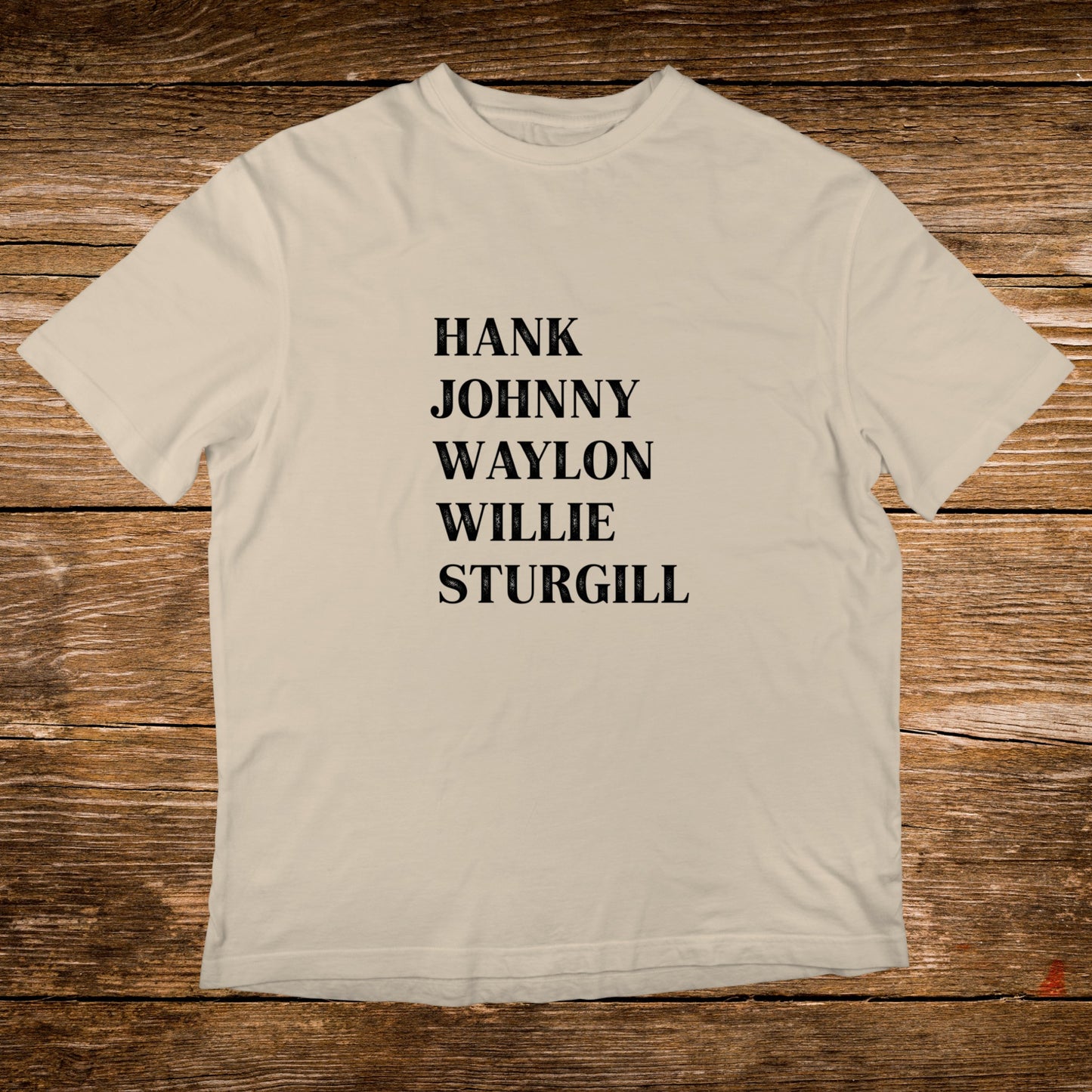 Cream t-shirt with black text listing Hank, Johnny, Waylon, and Sturgill.
