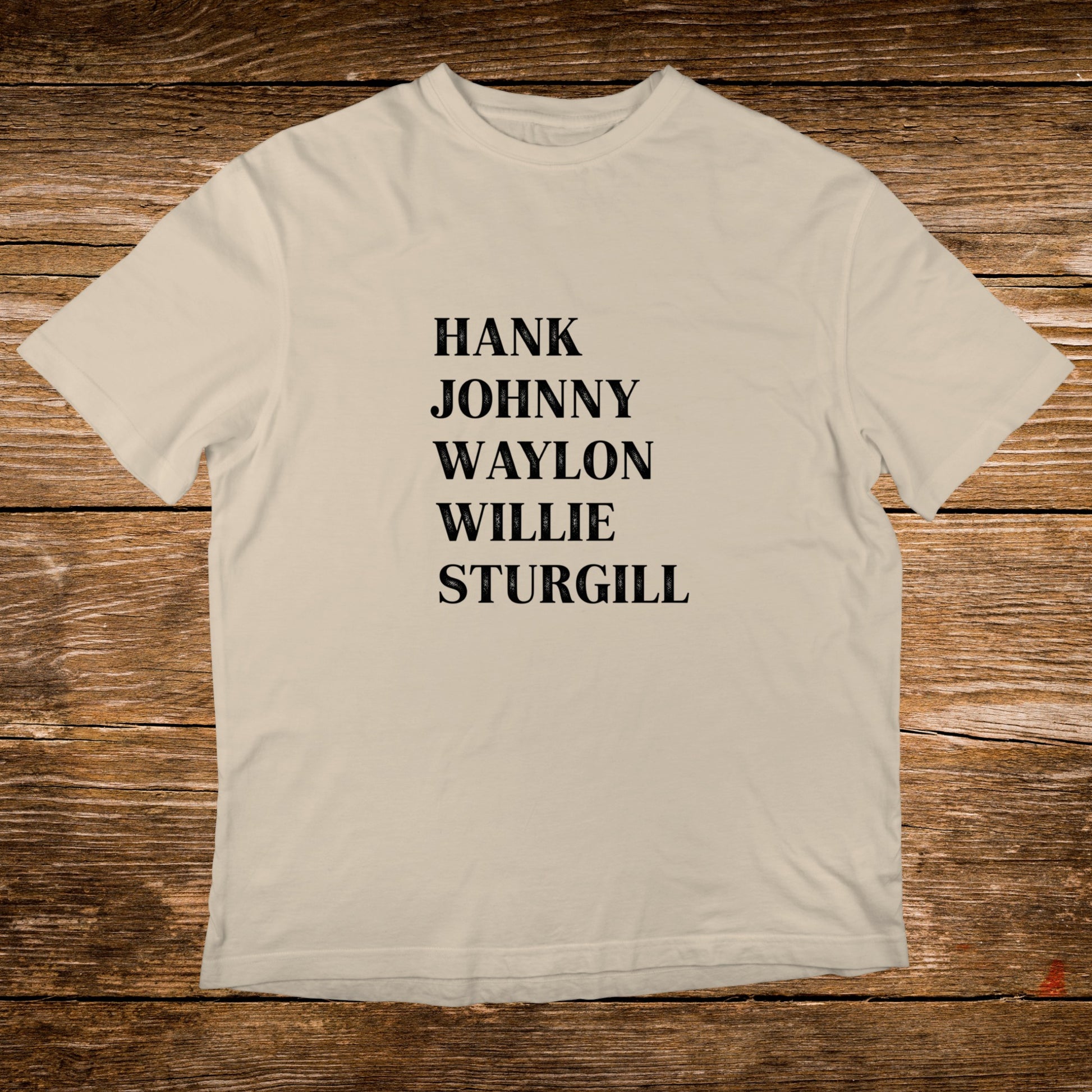 Cream t-shirt with black text listing Hank, Johnny, Waylon, and Sturgill.