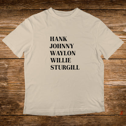 Cream t-shirt with black text listing Hank, Johnny, Waylon, and Sturgill.
