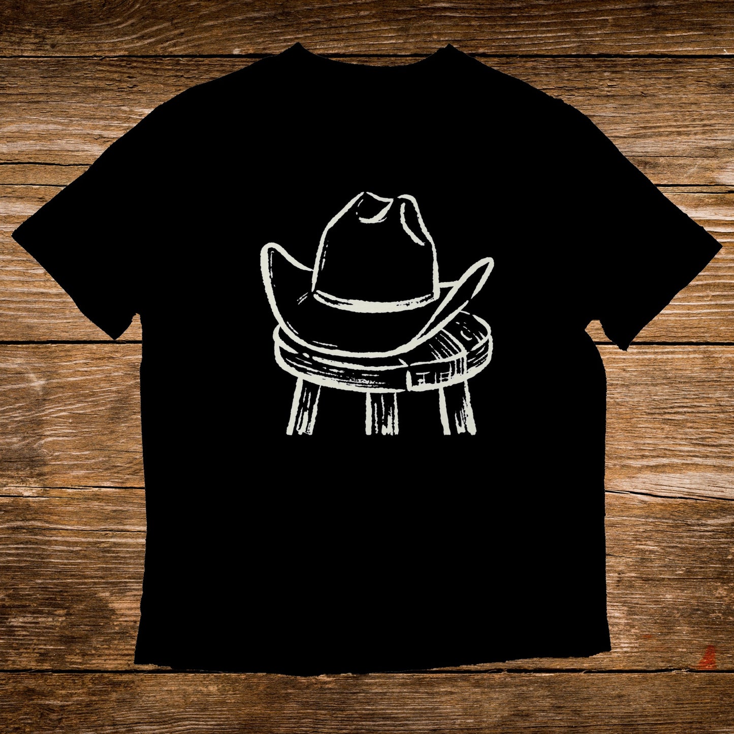 Black t-shirt with white sketch of a cowboy hat on a stool.