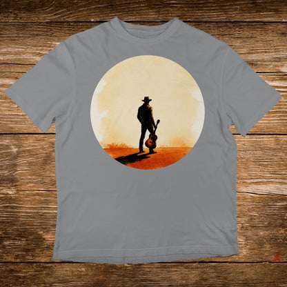 Cowboy with guitar silhouetted against a large, pale sun.