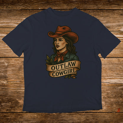 Navy t-shirt with "Outlaw Cowgirl" text and a stylized portrait of a woman.