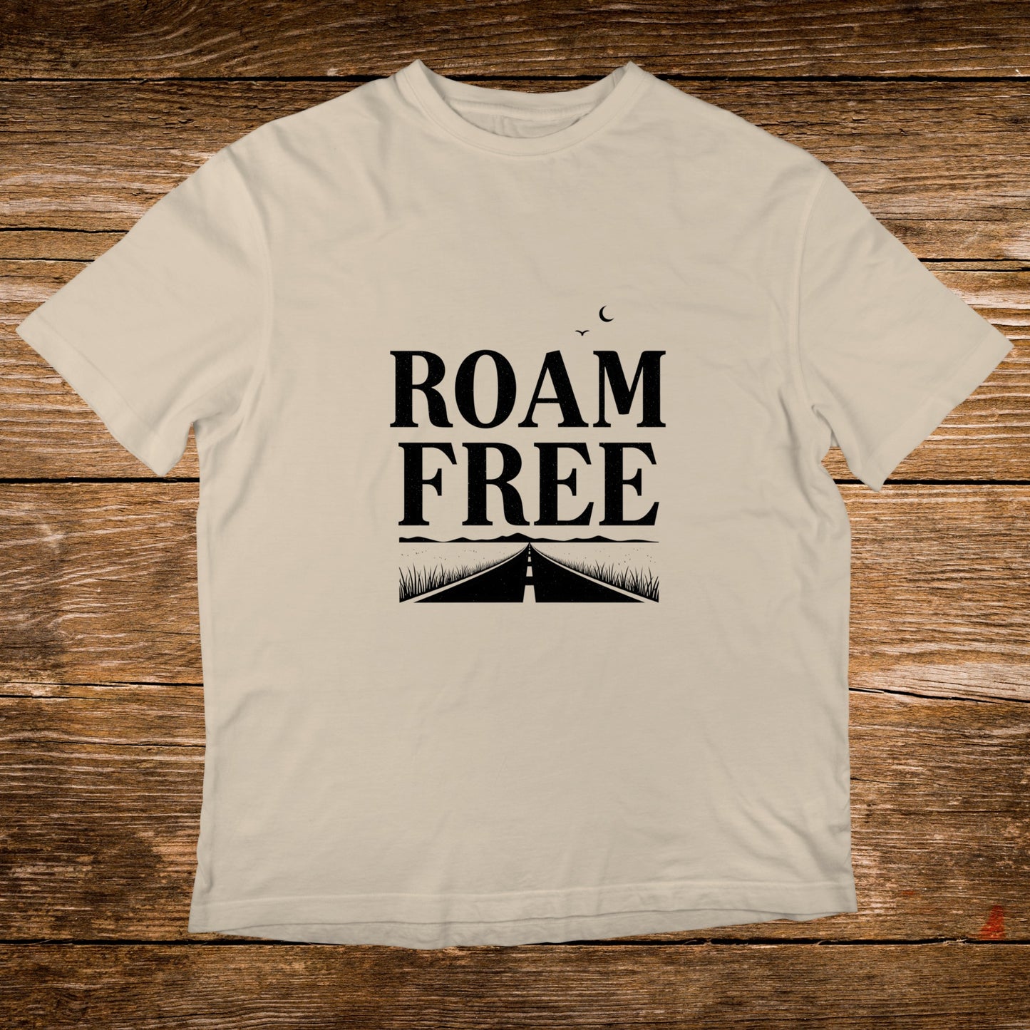 Cream t-shirt with "ROAM FREE" text and road graphic.