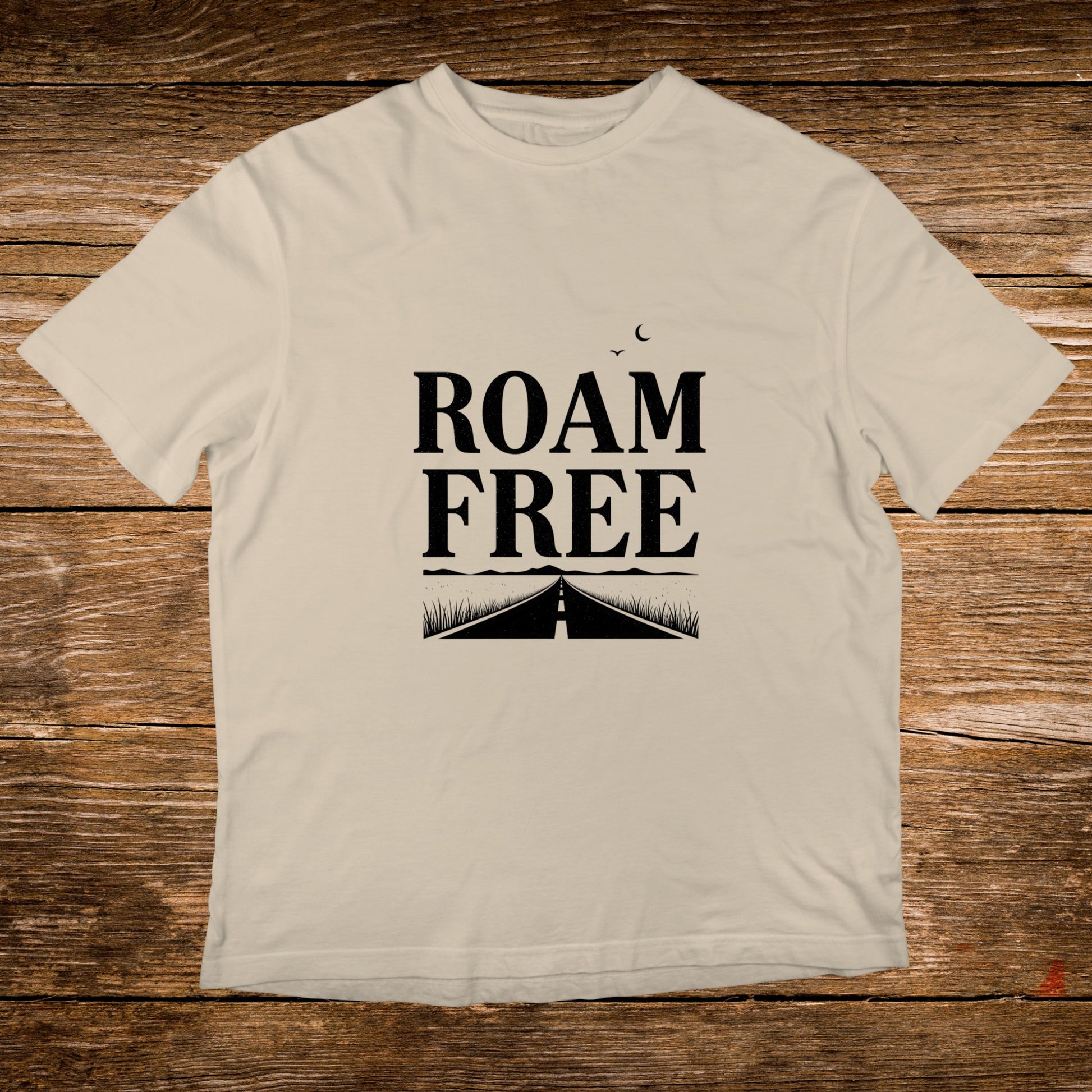 Cream t-shirt with "ROAM FREE" text and road graphic.