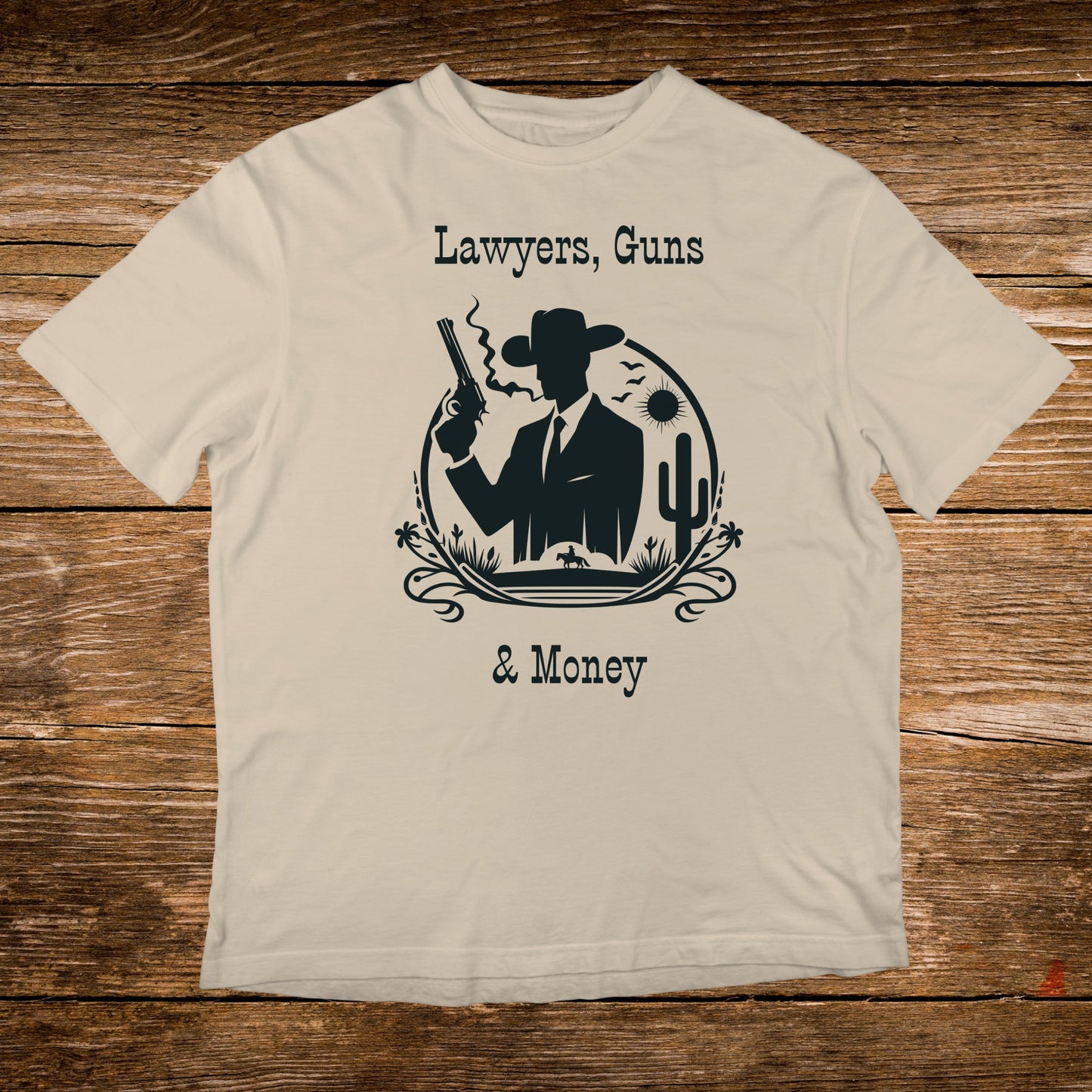 T-shirt with silhouette of cowboy, gun, cactus, and text: Lawyers, Guns & Money.