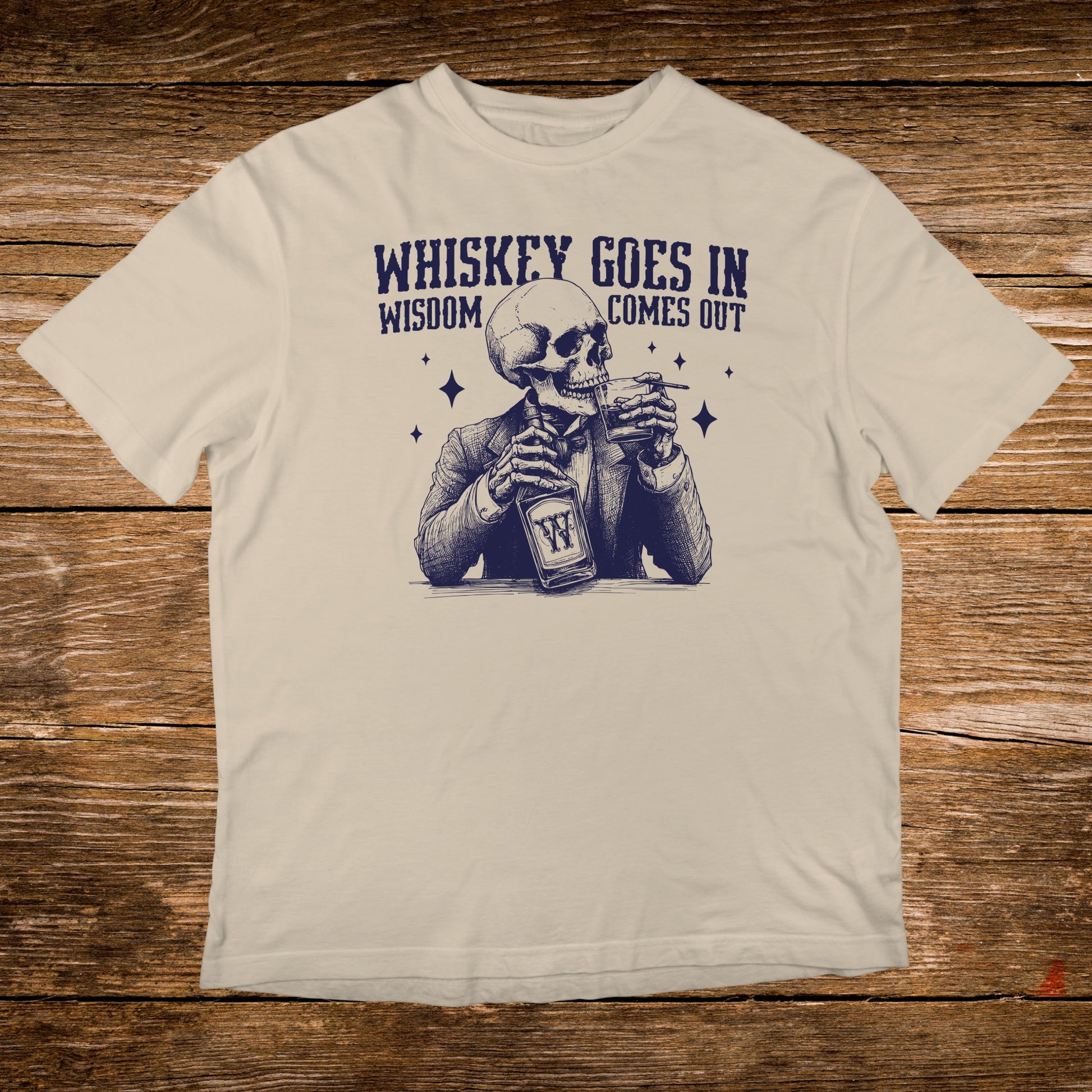 T-shirt graphic of a skeleton in a suit drinking whiskey, text reads "Whiskey goes in, wisdom comes out."