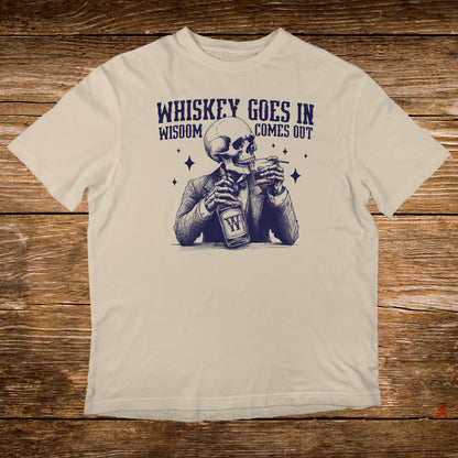 T-shirt graphic of a skeleton in a suit drinking whiskey, text reads "Whiskey goes in, wisdom comes out."