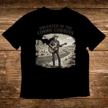 Black t-shirt with graphic of woman in cowboy hat playing guitar on desert road.