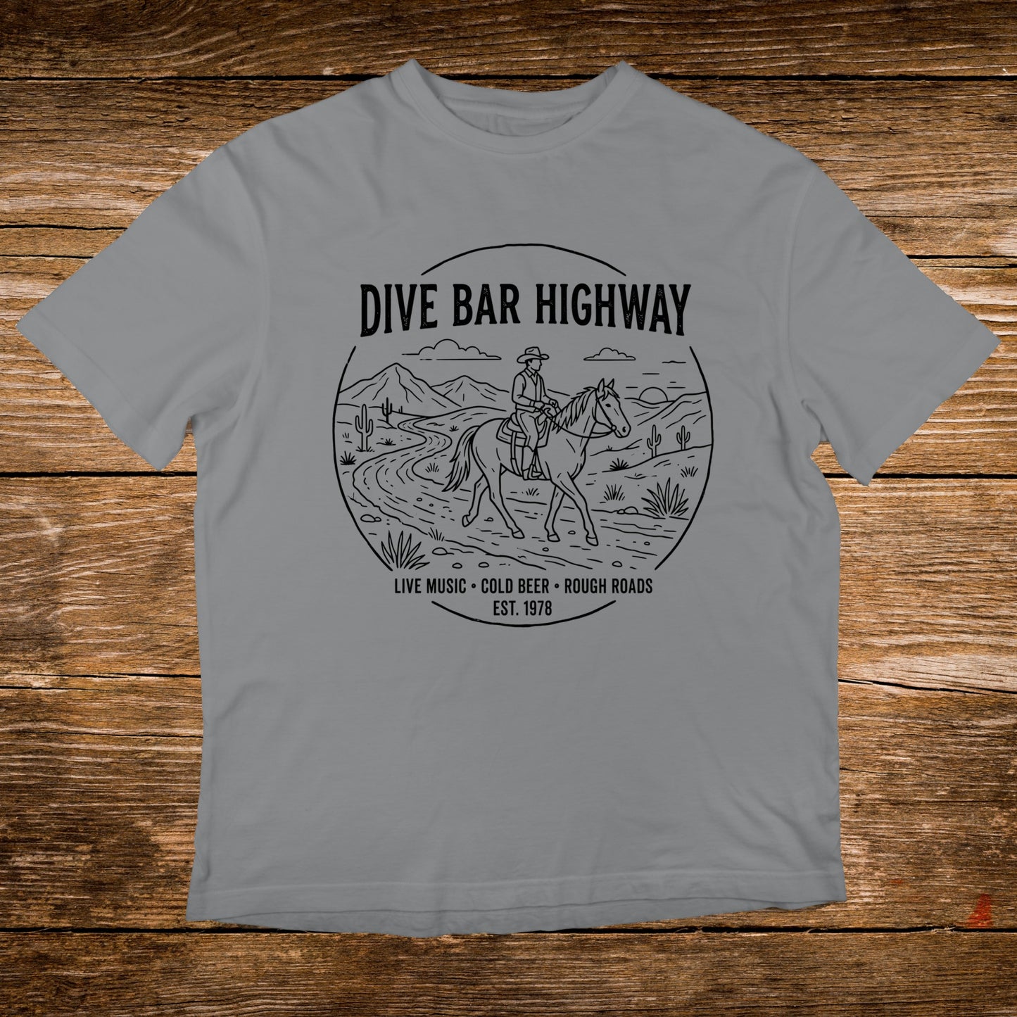Grey t-shirt with "DIVE BAR HIGHWAY" text and a cowboy on horseback.