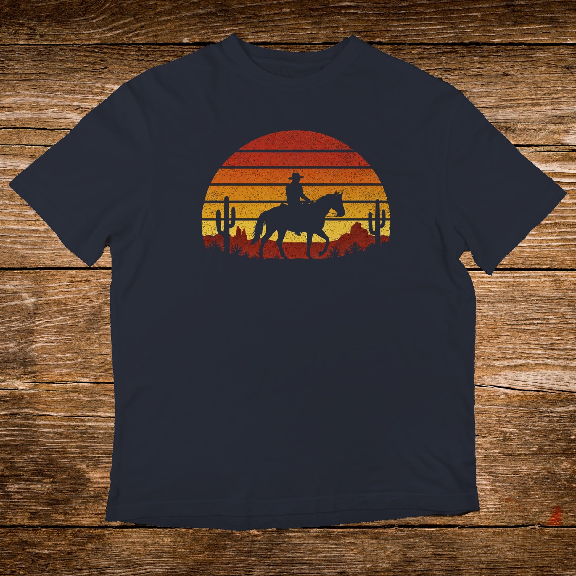 Sunset graphic with cowboy on horseback and desert cacti on navy t-shirt.