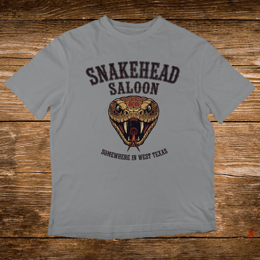 Grey t-shirt with Snakehead Saloon logo featuring a snake's head and "Somewhere in West Texas" text.