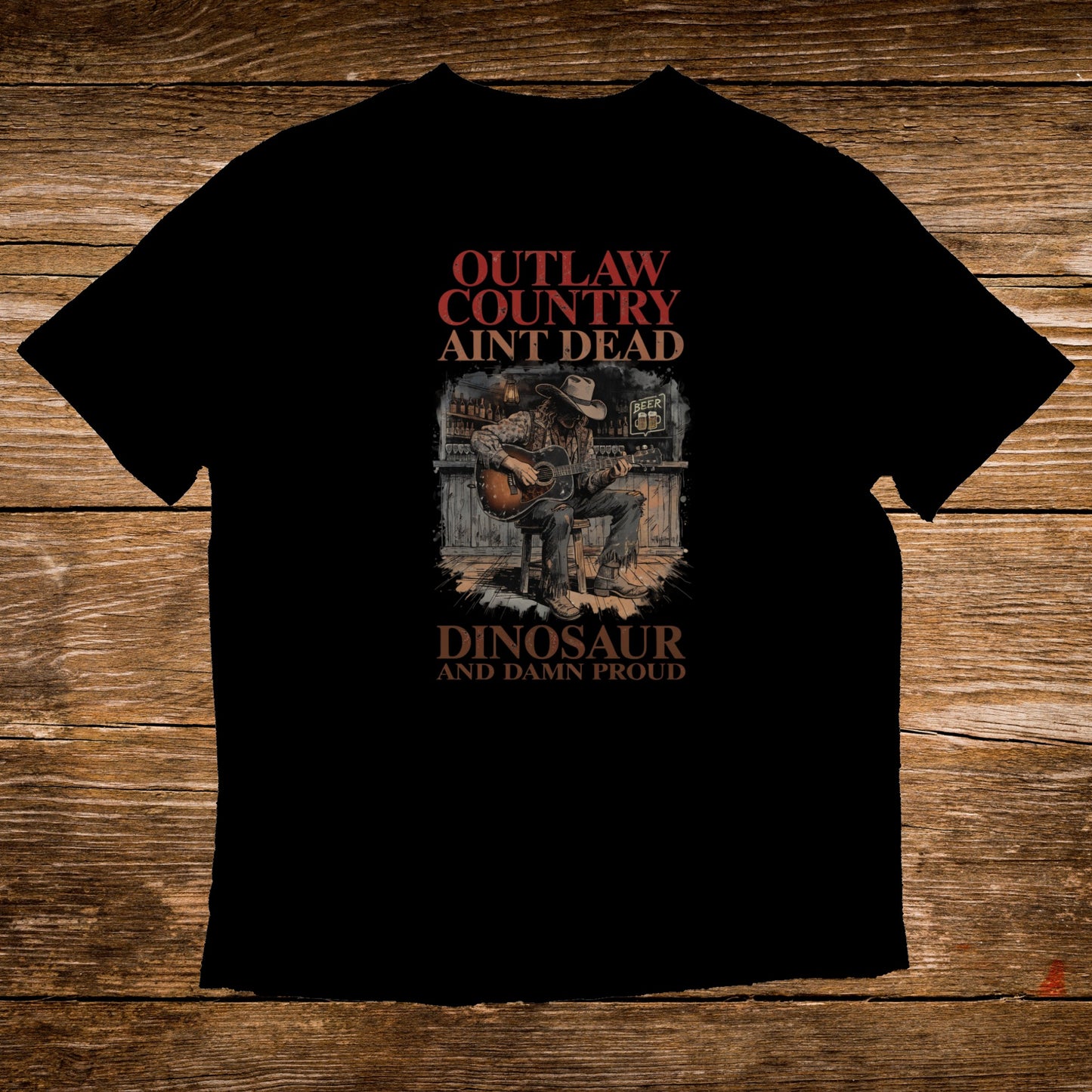 T-shirt with "Outlaw Country Ain't Dead" and cowboy playing guitar graphic.
