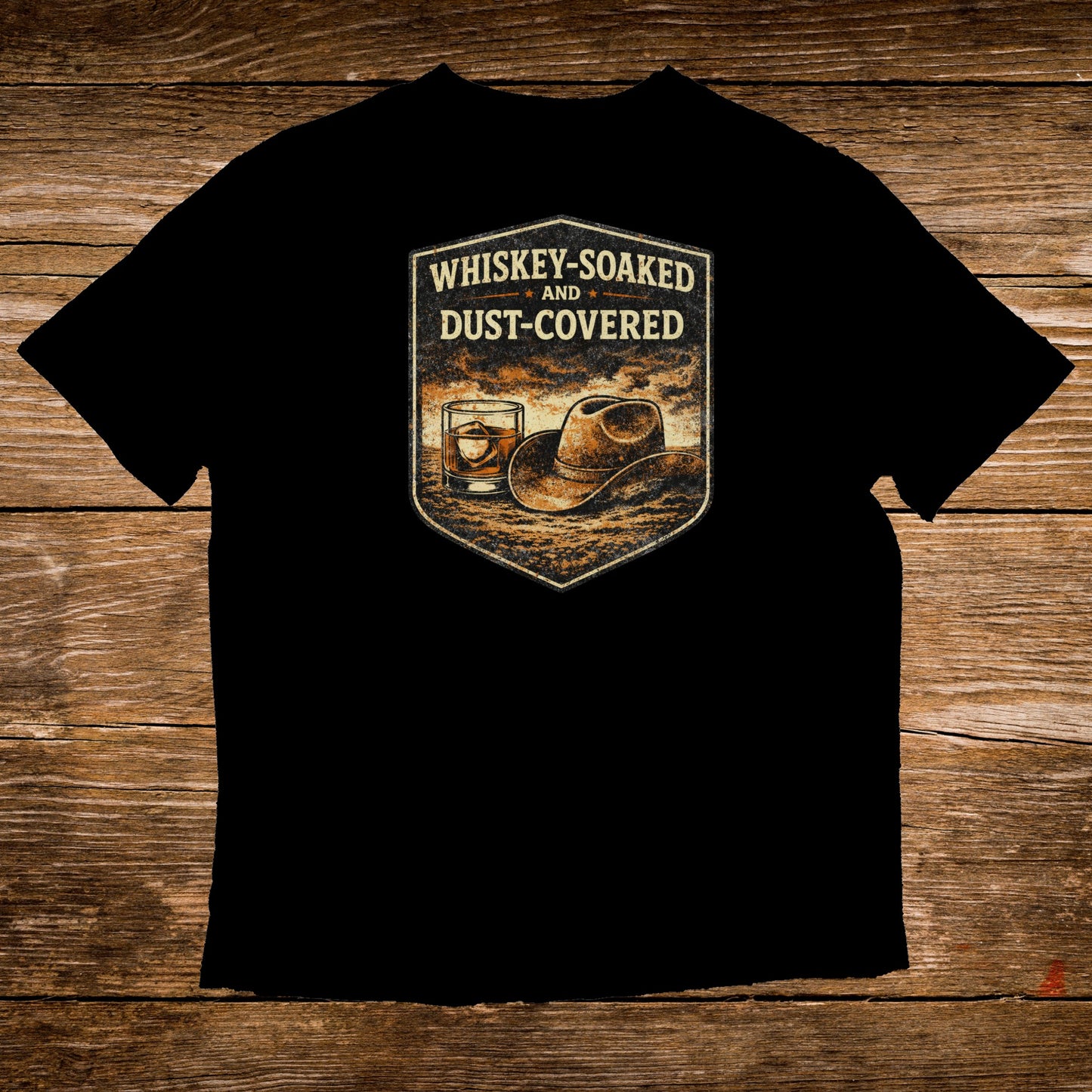 Black t-shirt with whiskey glass, cowboy hat, and text "Whiskey-Soaked and Dust-Covered".